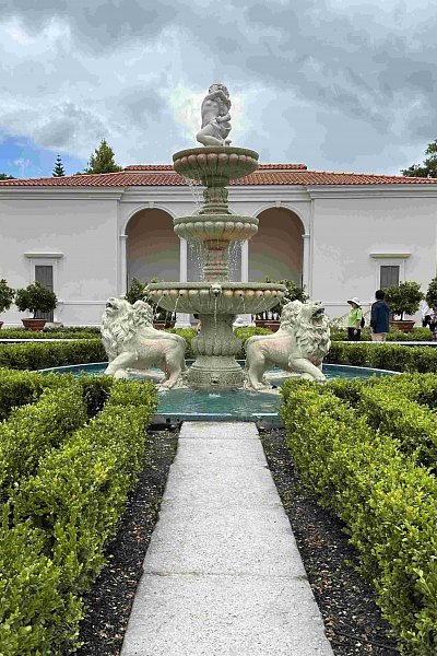 Formal Italian Renaissance Garden with central fountain, lion statues, neat hedges, and white pavilion at Hamilton Gardens, a stylish stop on the Auckland to Wellington drive.